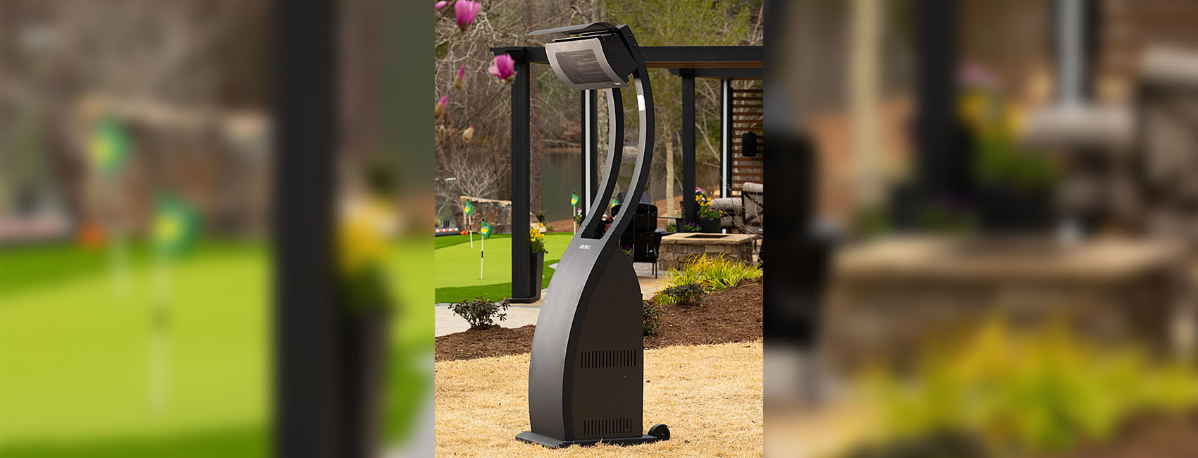 One portable freestanding patio heater next to a walkway on a golf course