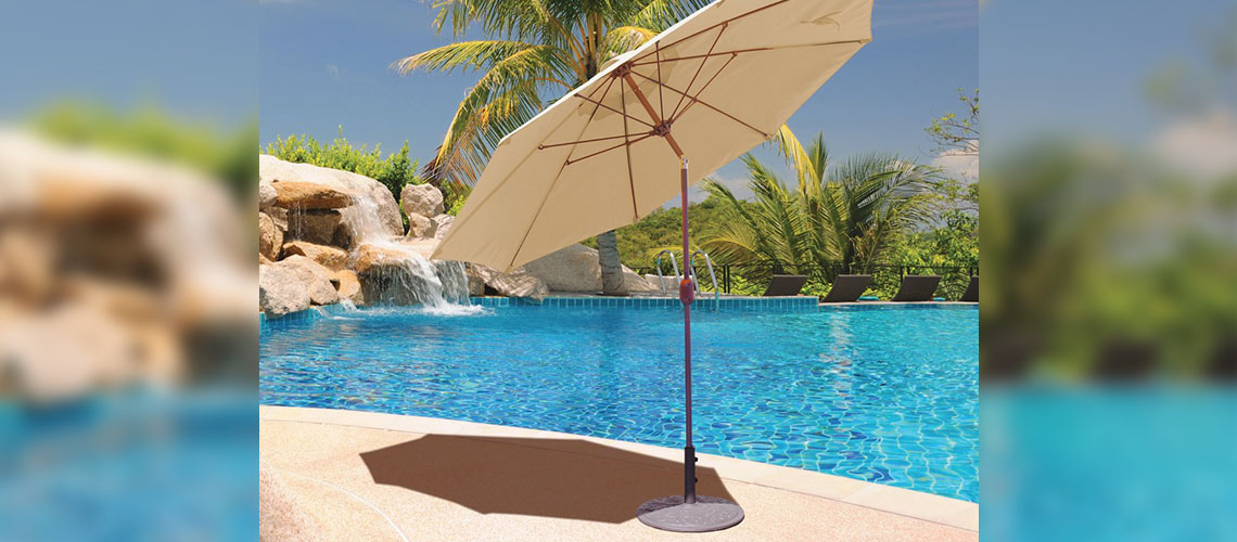 One Beige Round Umbrella Next to a Pool