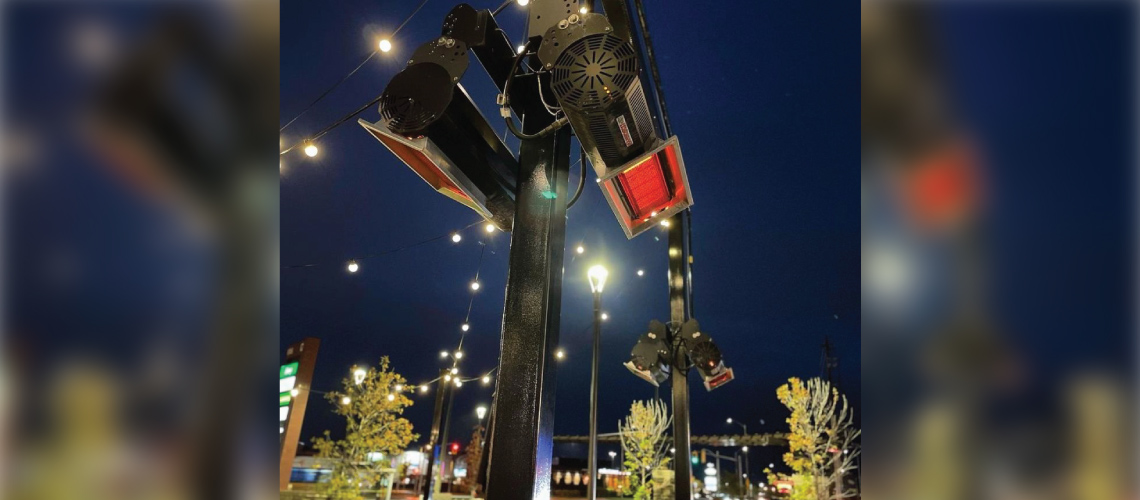 Exterior patio shot at night showing a close up of IR Energy Inc.’s Habanero HAB50NS mounted natural gas heater in black