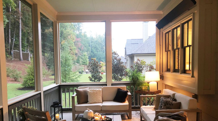 sreened porch with wood floor, area rug, wicker and wood furniture, beige walls almost entirely made of screened areas, with large IR Energy Inc. eWave EW32L24 long wave heater