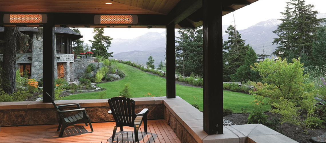 Indoor/outdoor patio in contemporary style overlooking a foggy mountain, with cherry floors, and wood ceiling from which hang two white Innova EF60240S electric infrared patio heaters