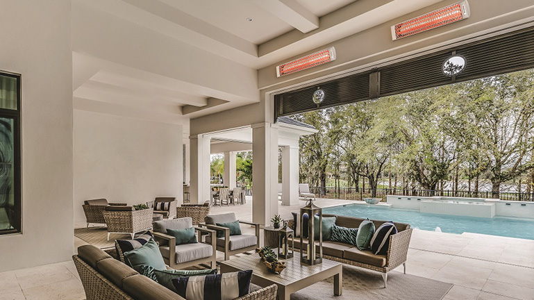 Two Electric Outdoor Heaters with a White Finish Mounted Above Outdoor Covered Patio