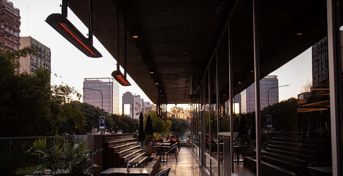 Four Electric Patio Heaters Hanging from the Ceiling of an Outdoor Patio of a Rooftop Restaurant in the Downtown Area of a City