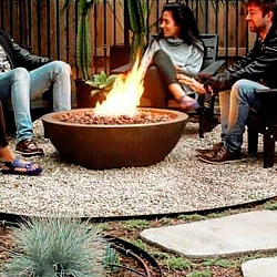 group of people around a lit fire pit