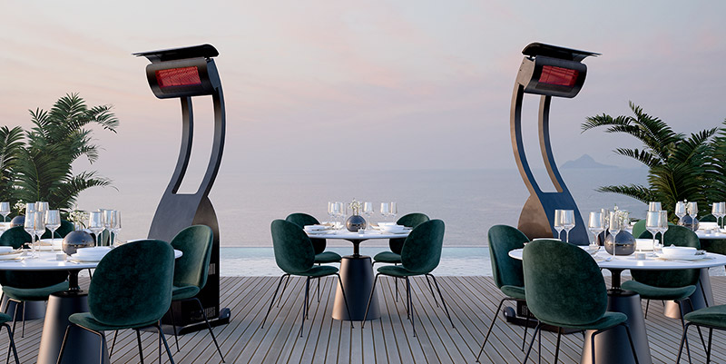 two of the best outdoor heaters freestanding on a restaurant deck facing a lake