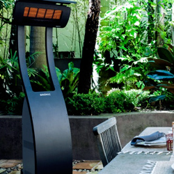 standing heater by a dining table in front of greenery