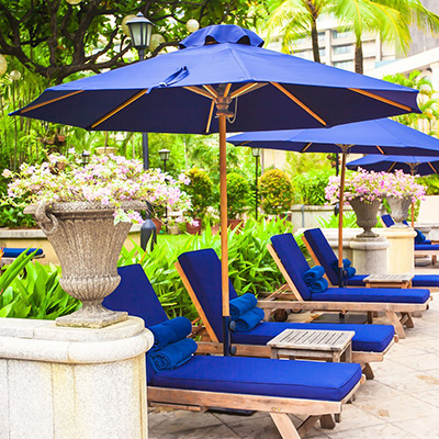 blue market umbrella shading blue lounge deck chairs