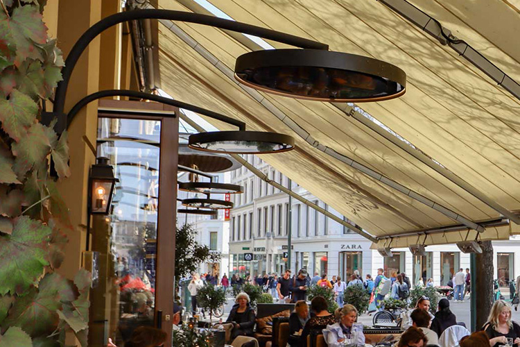 a bromic eclipse pendant with wall mount option heating a lively crowded restaurant 