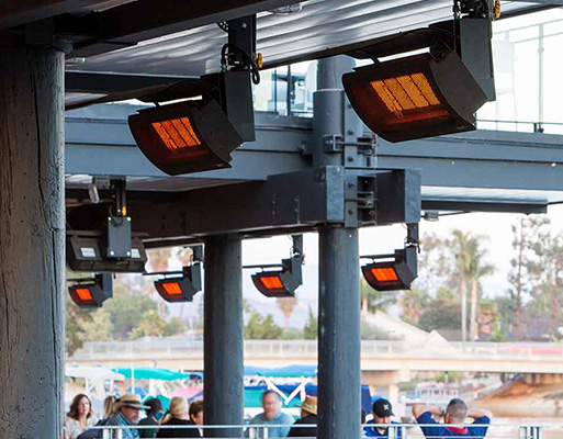 hanging gas tungsten heaters over a patio with a foggy mountain view