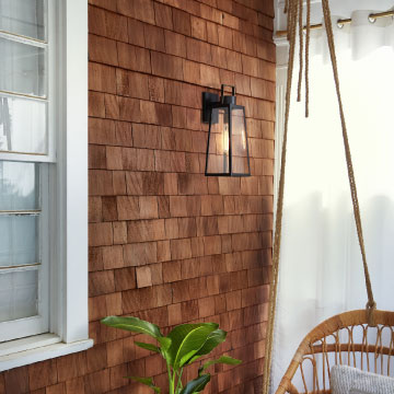 black wall light on a wood shingled exterior wall